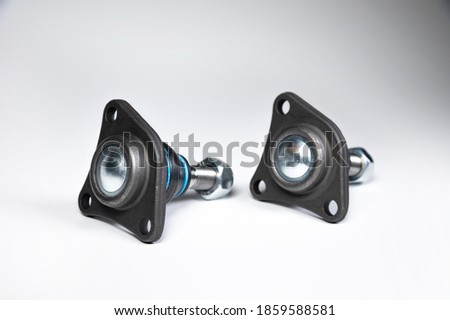 Two ball joint car suspension on a gray background. New spare parts axel car elements