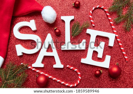 Winter Christmas sale white text SALE on red festive shiny background. flat lay top view