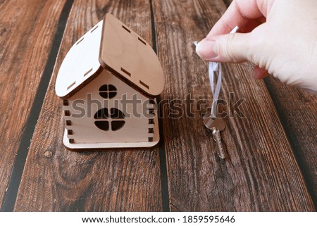 
house model for sale with money, key on background, house for sale concept, closeup