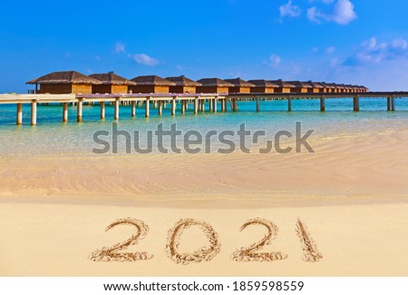 Numbers 2021 on beach - concept holiday background