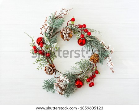Christmas wreath on a white wooden background. Bright new year's holiday design. Minimalism is a top view of a flat layout natural sunlight. Greeting card made of spruce branches with a place to copy