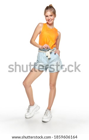 Beautiful young girl in casual wear isolated on white studio background.