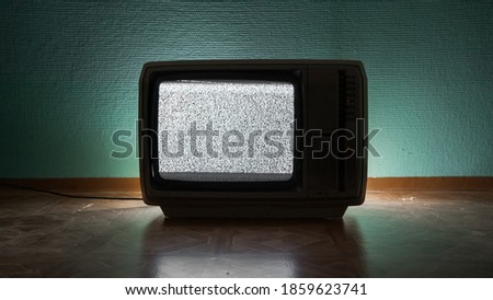 Old TV agains green background