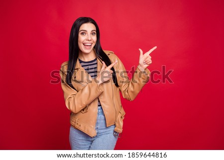 Portrait of excited cheerful lady indicate two hands fingers empty space proposition isolated on red color background