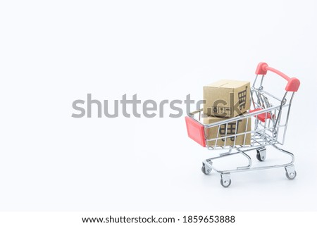 Shopping concept - Cartons or Paper boxes in red shopping cart on white background. online shopping consumers can shop from home and delivery service. with copy space
