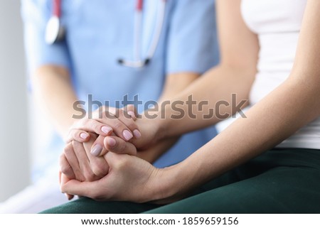 Patient's and doctor's hands are folded together. Medical care and support concept Royalty-Free Stock Photo #1859659156