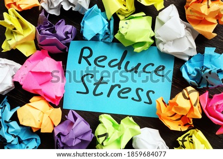 Reduce stress memo and colorful paper balls. Royalty-Free Stock Photo #1859684077