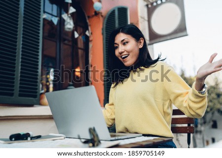 Amazed hipster girl watching interesting education webinar during e learning in street cafe, shocked female freelancer connecting to 4g wireless internet for making distance job surprised with speed
