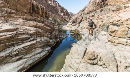 Hiking through Wadi Shawka in Ras Al Khaimah, UAE Royalty-Free Stock Photo #1859708599