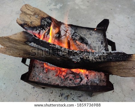 uttarakhand,india-320 november 2020:this is a picture of burning wood.this is burnt to form coals in the winters.flames coming out of burning wood.