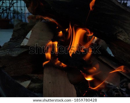 uttarakhand,india-3 november 2020:this is a picture of burning wood.this is burnt to form coals in the winters.flames coming out of burning wood.