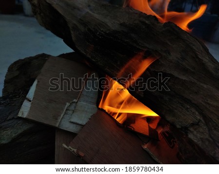 uttarakhand,india-30 november 2020:burning wood.this is burnt to form coals in the winters.flames coming out of burning wood.