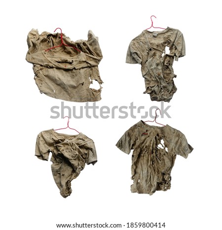 A clothes hanger hangs old clothes ragged on a white, rag. Royalty-Free Stock Photo #1859800414
