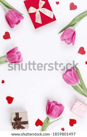 Pink tulip flowers gifts red hearts and gifts composition isolated on white background top view with copy space. Valentine's day, birthday, wedding, Mother's day concept. Copy space