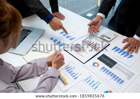 Team of business people working together in the meeting room office,
teamwork background charts and graphs banner, double exposure successful teamwork,business planning concept.
