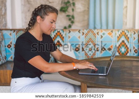 Working from distance. Young freelance woman working on laptop. Quarantined office employee using laptop