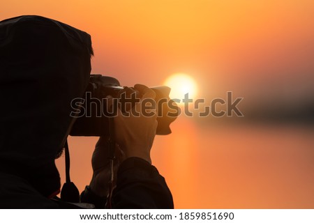 Photographer tourists taking pictures during sunset Silhouette  time.