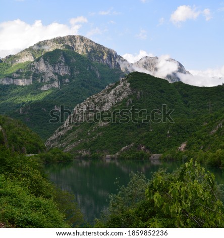 Photo of a mountain with green trees and rocks and a river in Bosnia and Herzegovina