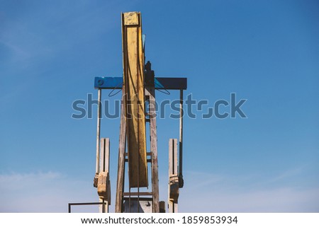 pumpjack close up against the sky