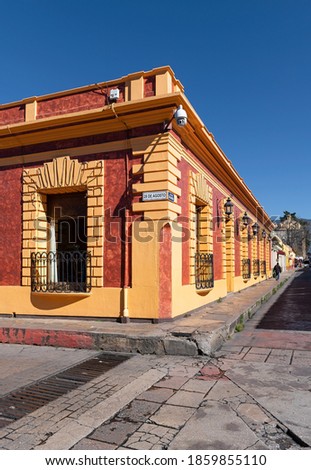 Street corner with colonial style architecture, San Cristobal de las Casas, Chiapas, Mexico. Translation: Street 28 of August, El Cerrillo district. Royalty-Free Stock Photo #1859855110