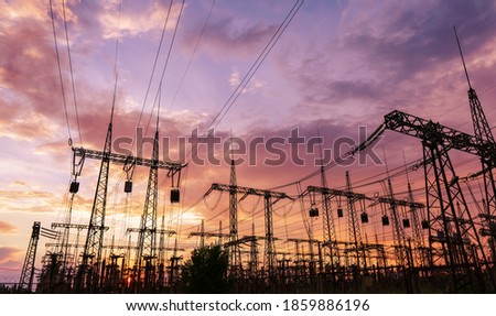 distribution electric substation with power lines and transformers, at sunset Royalty-Free Stock Photo #1859886196