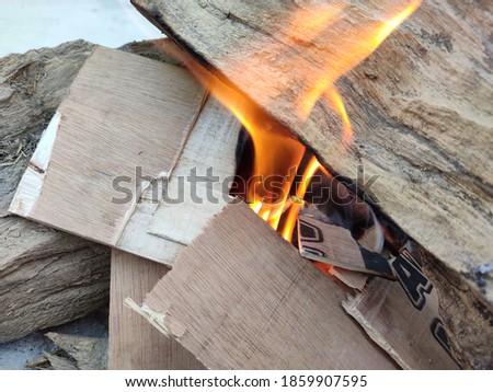 uttarakhand,india-30 november 2020:picture of burning wood.this is burnt to form coals in the winters.flames coming out of burning wood.