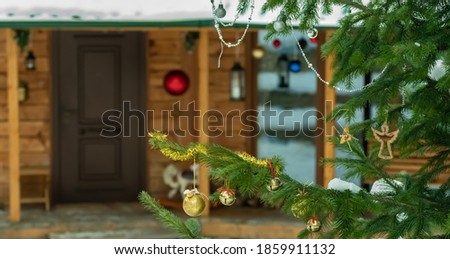 Christmas tree in the yard of a wooden house