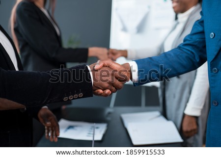 A close-up of two black men shaking hands. Investor and developer two African Americans shake hands. Royalty-Free Stock Photo #1859915533