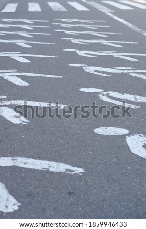Pedestrian crosswalk with drawings of a person on the asphalt