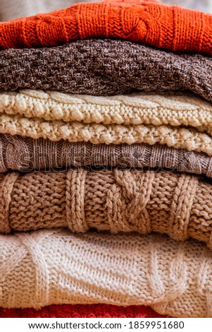 Pile of woolen clothes close up as a background