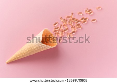 Pile of capsules Omega 3 on pink background. Close up, top view, high resolution product.