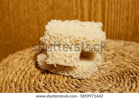 Slices of fresh gray bread on a wooden background. Close-up, selective shot.