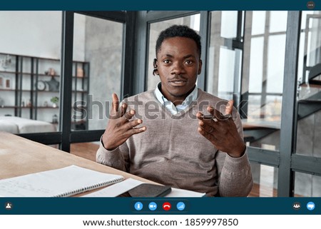 African business man coach, executive wearing headset talking to camera conference video calling, giving webinar, online class, distance teaching by videoconference, web cam view. Headshot, screenshot Royalty-Free Stock Photo #1859997850