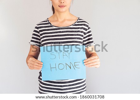 Woman shows stay home sign during virus outbreak close up