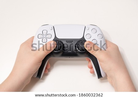 New Next Gen game controller on Kids Hand. Royalty-Free Stock Photo #1860032362