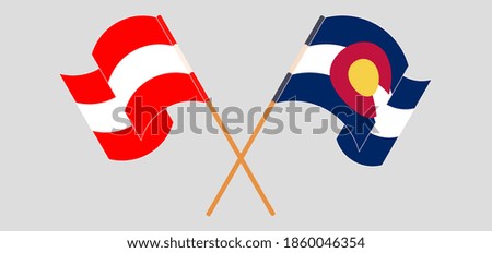 Crossed and waving flags of Austria and The State of Colorado