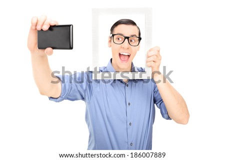 Man taking a selfie and holding a picture frame isolated on white background
