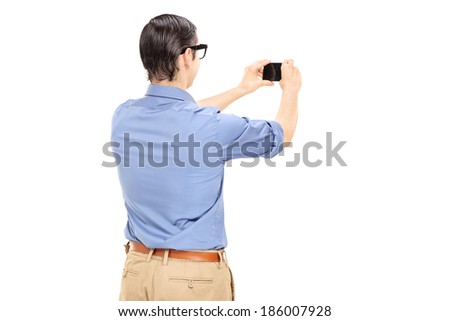 Man taking a picture with cell phone isolated on white background