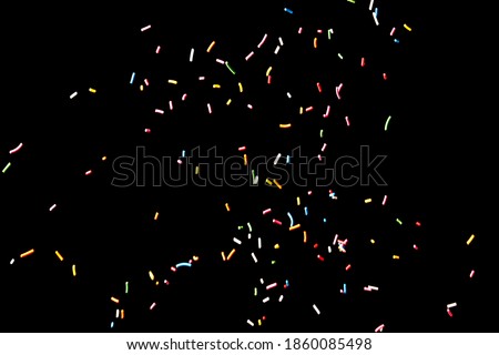 Sugar sprinkle dots on a black background Royalty-Free Stock Photo #1860085498