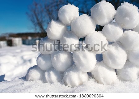 Snowballs lie on the snow. Children's winter games. Background