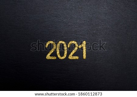 Happy New year 2021. Golden digits 2021 flat lay with copy space on black background. Golden numbers 2021. 