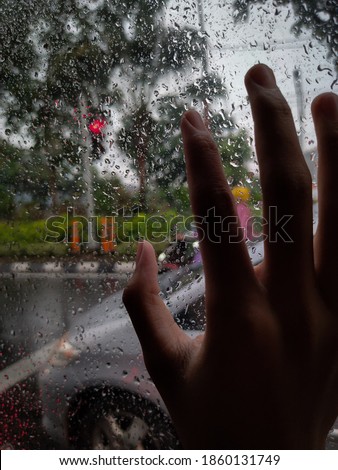 Rainy day in the car with sad song played. 