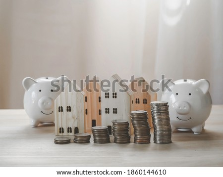 Piggy bank, money coins stack growing graph and wood house model. Investment in the real estate business. concept saving for the future . 