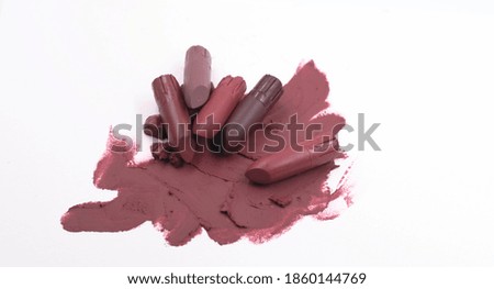 Lipstick smears on background,show texture and color of cosmetic.