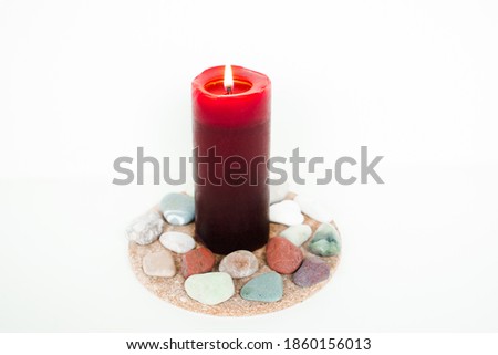 Assortment of red candle and rocks