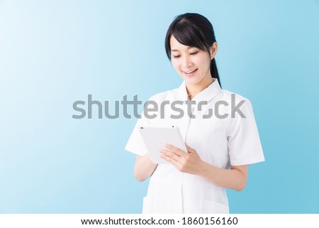 Young attractive asian nurse of the smile,tablet computer,