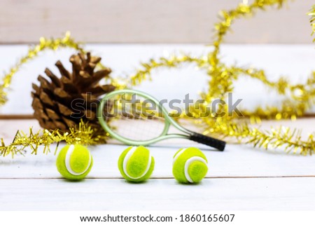 Tennis Christmas Holiday with Tennis ball and Christmas Ornament on wooden background