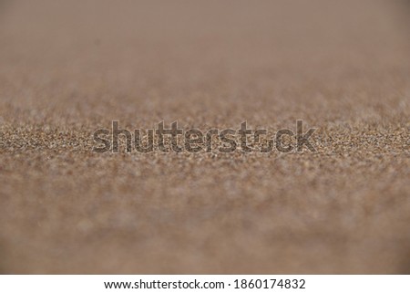 A picture of sand on a beach with depth of field that can be use as a background