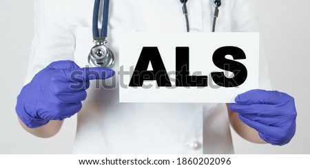 Medicine and health concept. The doctor points his finger at a sign that says - ALS. amyotrophic lateral sclerosis