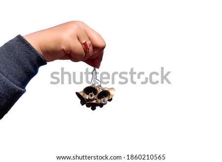 hand holding bunch of bells on white background. girl holding the temple bells.